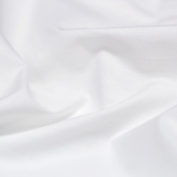 Detail of white cotton-polyester blend fabric of hotel sheets